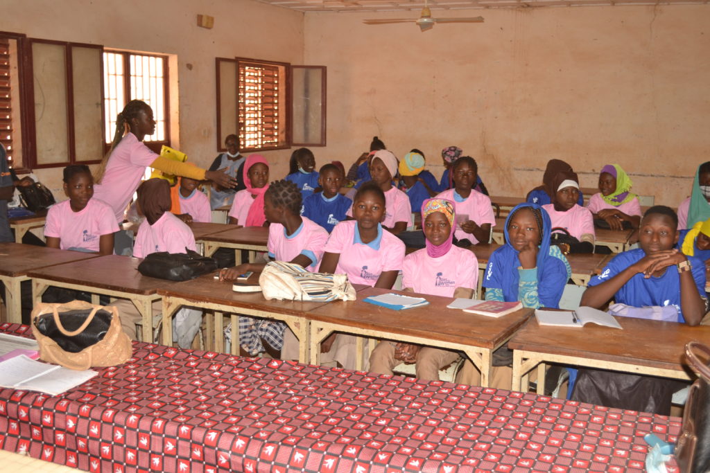 Girls listening to a lesson at our menstrual education workshop in school in Burkina Faso, West Africa.