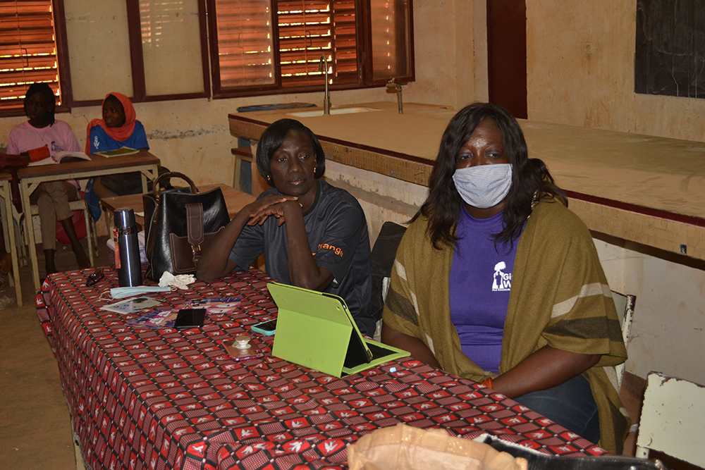 Program Coordinator Laure Congo and Bienvenue Konsimbo teaching a menstrual education workshop focusing on menstrual health and sanitation during COVID