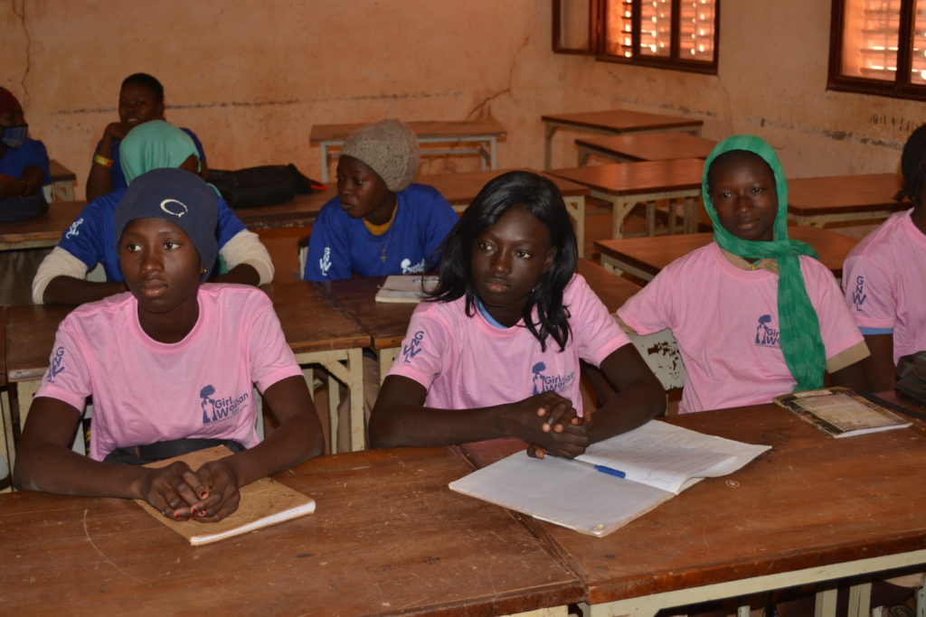Girls listening to a lesson at our menstrual education workshop in school in Burkina Faso, West Africa.