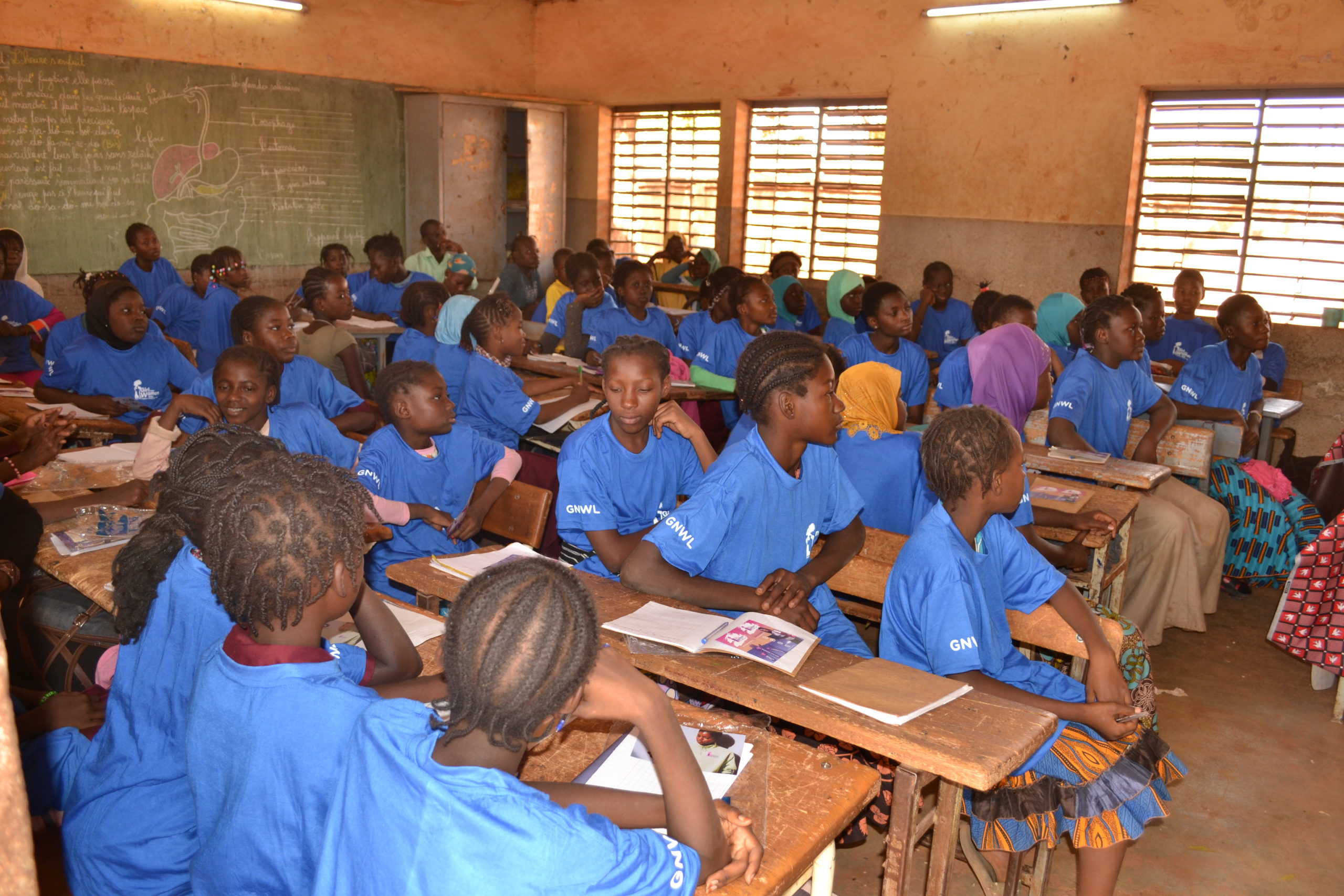 Girls listening to a lesson at our menstrual education workshop in school in Burkina Faso, West Africa.