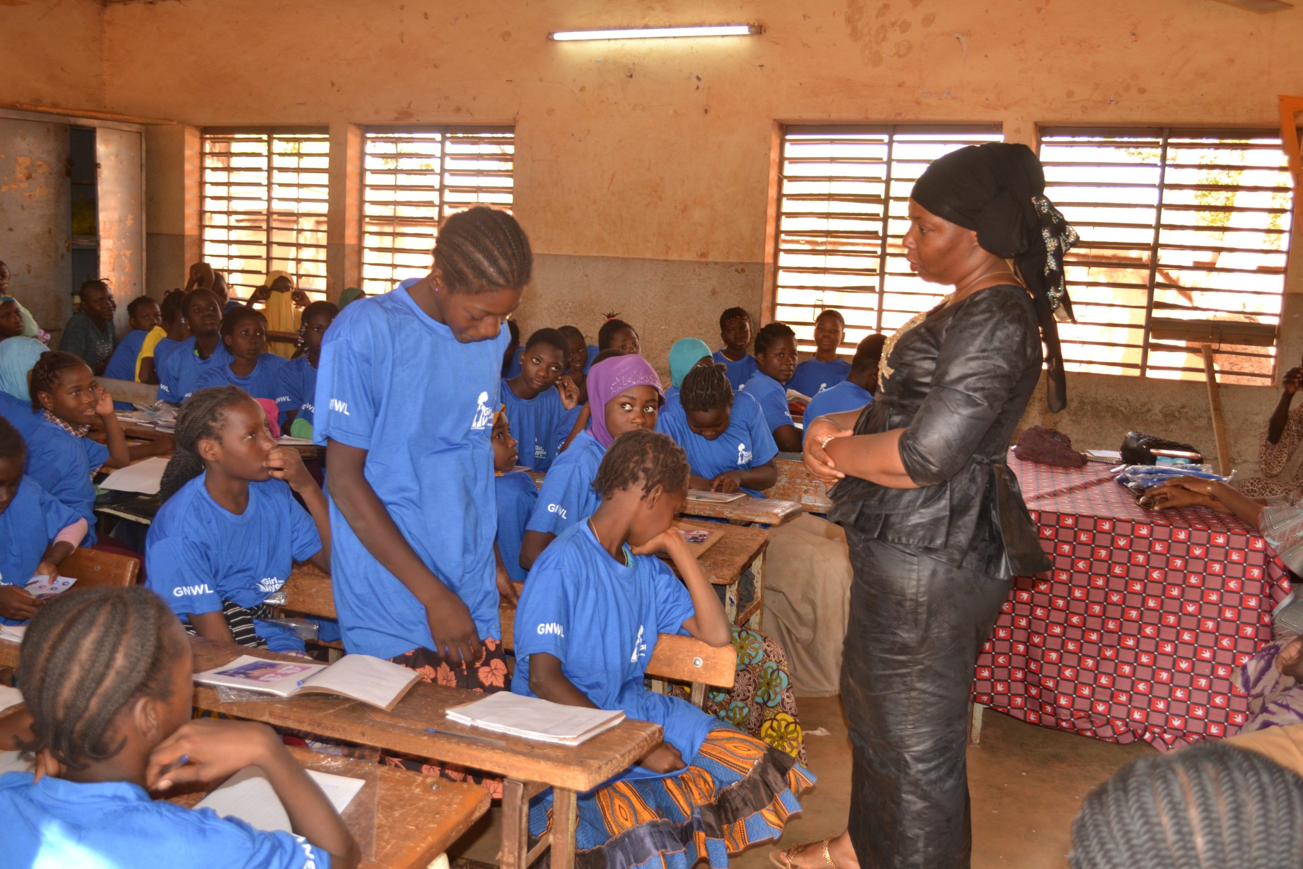 Girls giggling at a question asked by our menstrual education nurse-teacher Sakande Koanda Sonata at our period workshop in Nord-C school in Burkina Faso, West Africa.