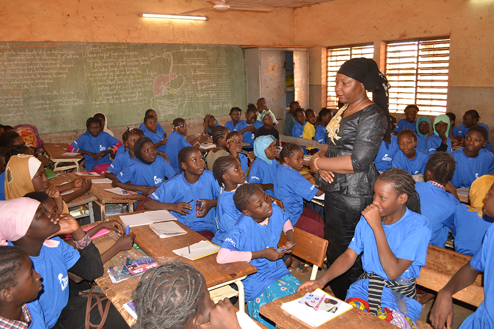 Girls giggling at a question asked by our menstrual mentor Sakande Koanda Sonata at our menstrual education workshop in Nord-C school in Burkina Faso, West Africa.