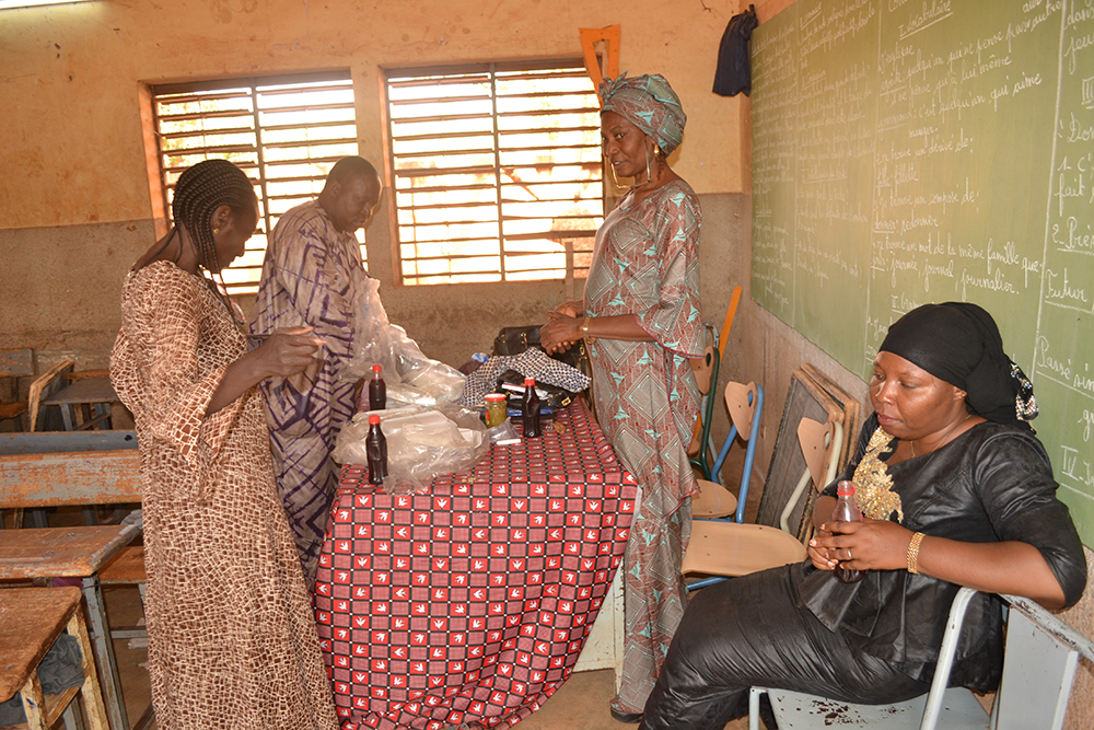 Girl Now Woman Later educators Laure Congo, Sakande Koanda Sanata, prepping for lunch during on of the period education classes