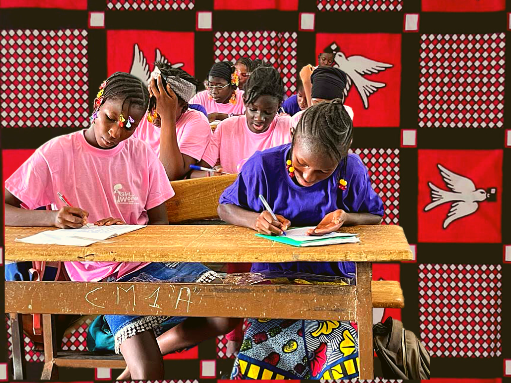 Girls writing in their notebooks at our menstrual education workshop in Nord-C school in Burkina Faso, West Africa. With the Luili Pende Cloth behind them.
