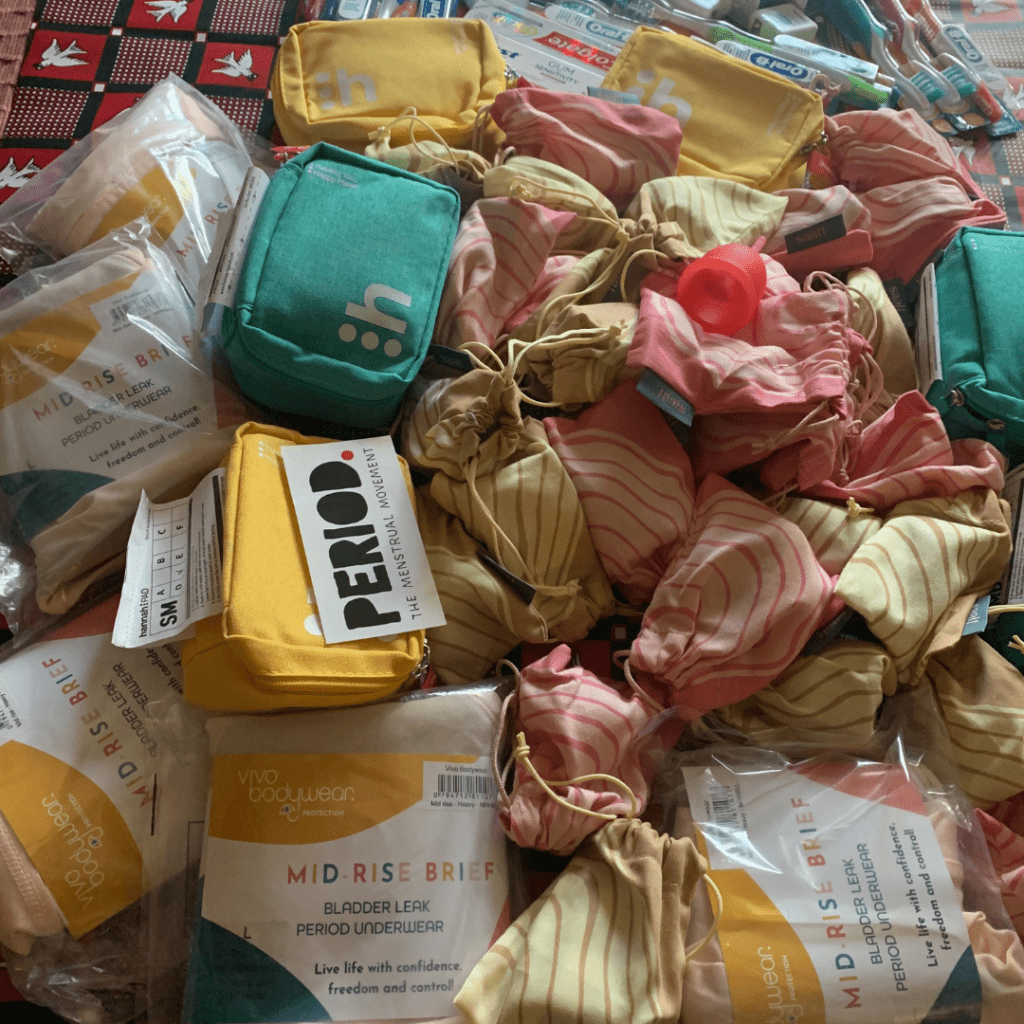 Period kits donation from Period.org showing menstrual cups, period underwear and period product zipper bags