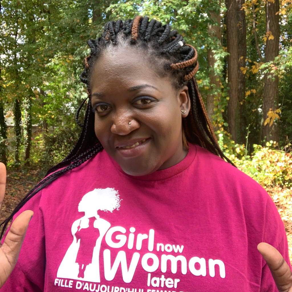 CEO Bienvenue Konsimbo wearing a pink girl now woman later t-shirt