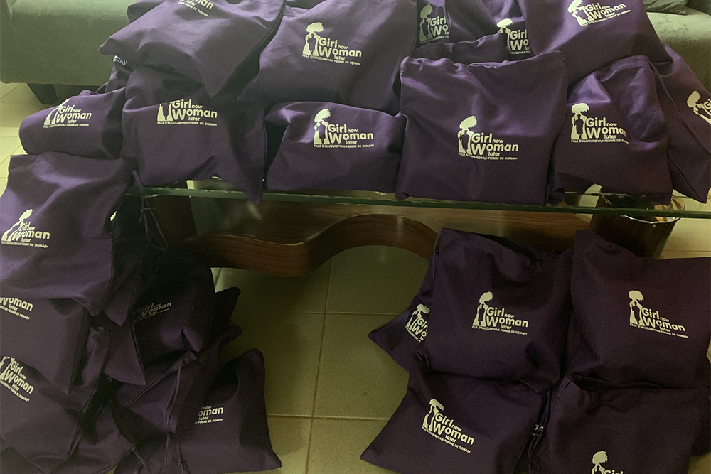 Girl now woman later purple bags